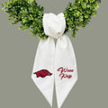 The Matthew John Collective white Arkansas wreath sash with red embroidered Razorback logo and Wooo Pig text