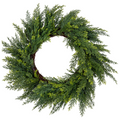 The Matthew John Collective 18-inch artificial cedar wreath with feathery green foliage on a rustic grapevine base.