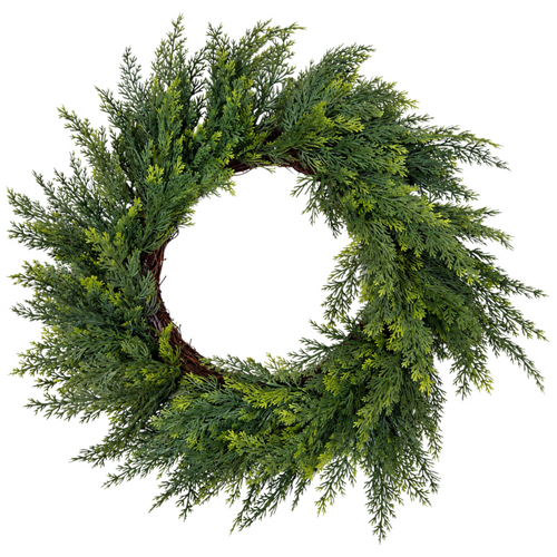 The Matthew John Collective 18-inch artificial cedar wreath with feathery green foliage on a rustic grapevine base.