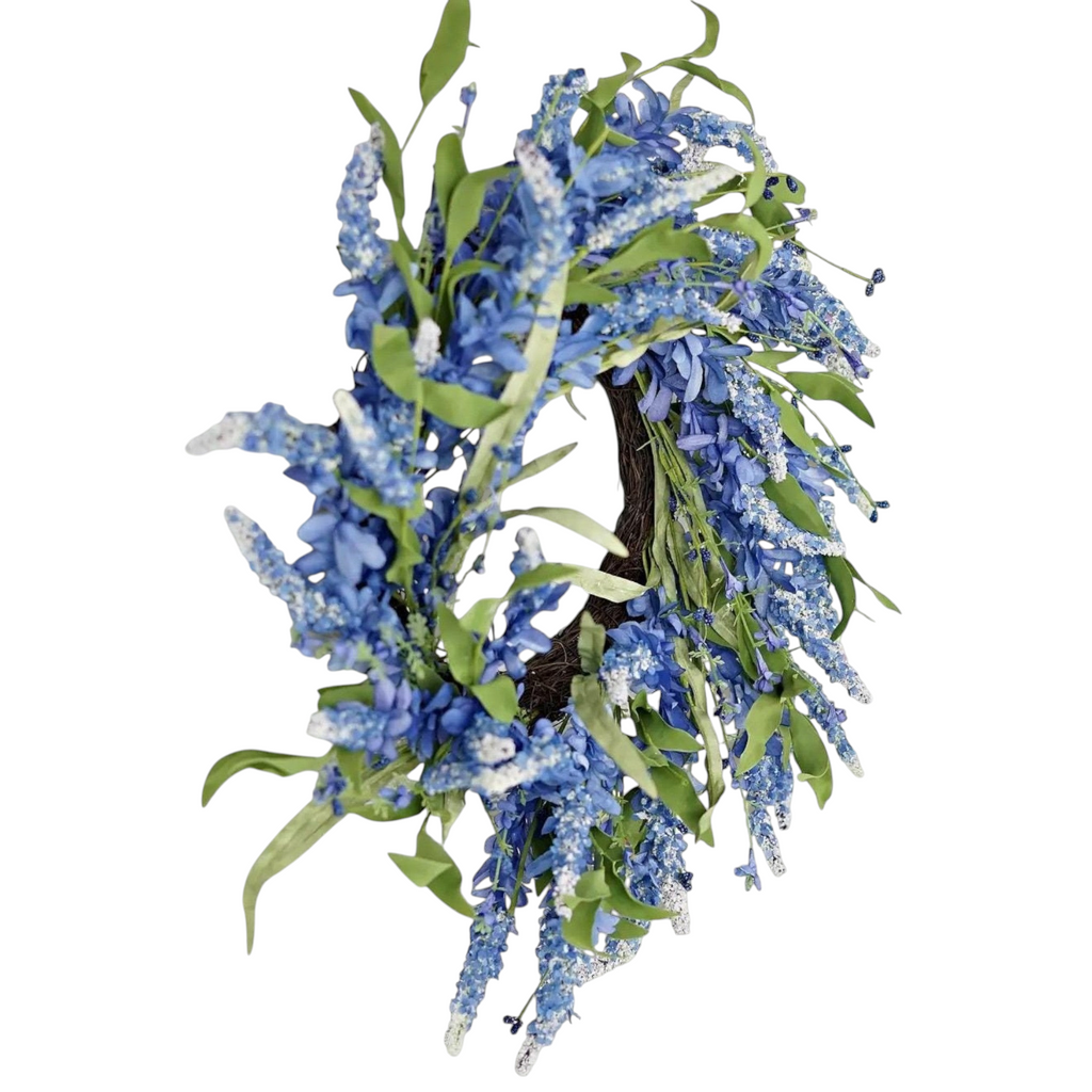The Matthew John Collective 24-inch blue floral wreath with periwinkle clusters, white-tipped botanicals, and greenery.