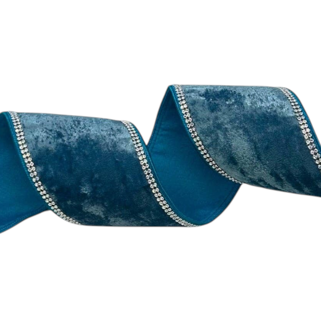The Matthew John Collective dusty teal crushed velvet wired ribbon with silver rhinestone edges on a spool.