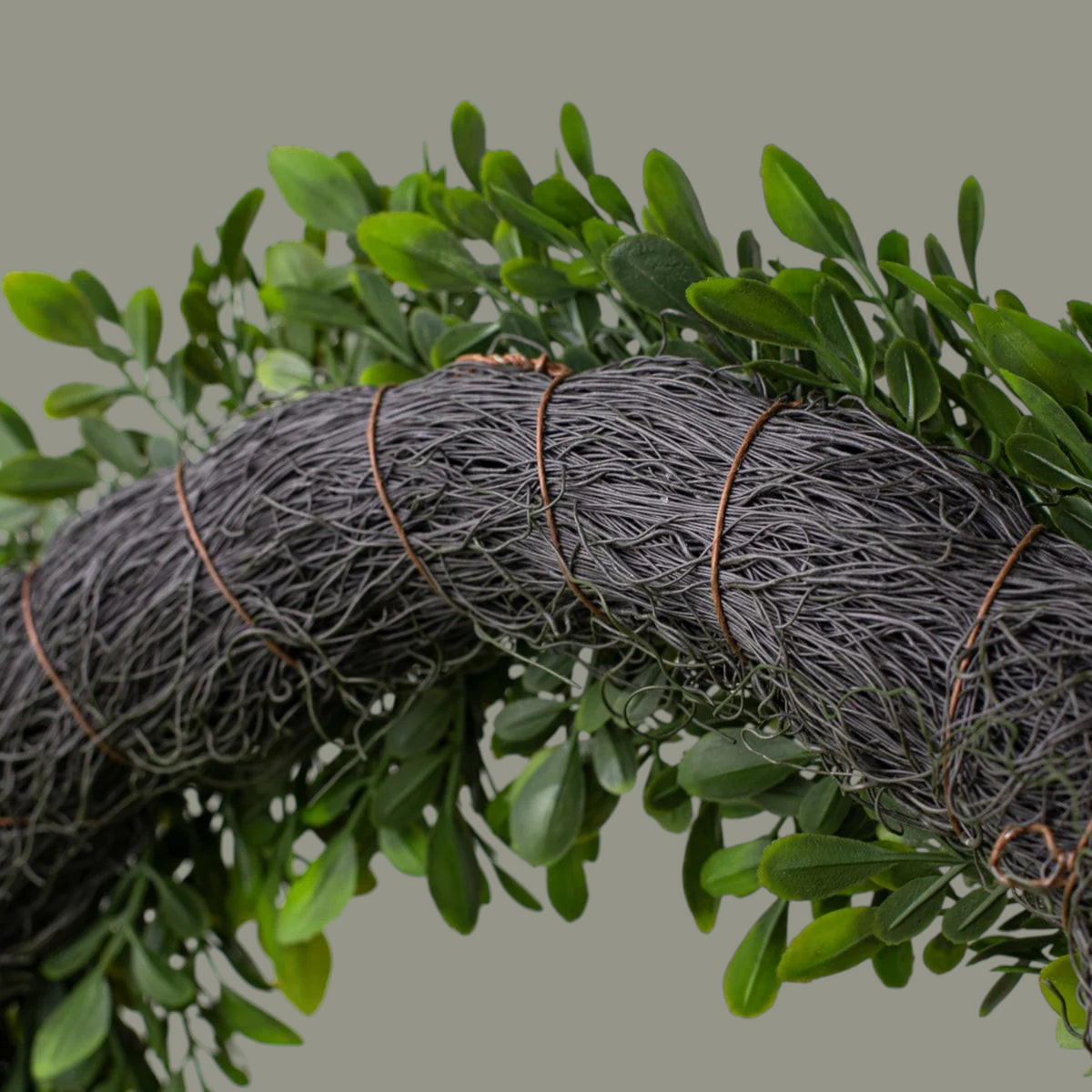 The Matthew John Collective 18-inch artificial boxwood wreath featuring lush green leaves on a dark twig frame