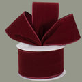 The Matthew John Collective burgundy velvet ribbon with wired edges on a spool for holiday and craft decorating.