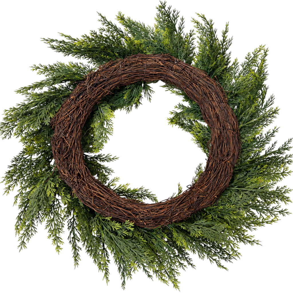 The Matthew John Collective 18-inch artificial cedar greenery wreath with feathery foliage on a rustic grapevine base.