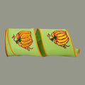 The Matthew John Collective 4-inch citrus green wired ribbon featuring shimmering sequined pumpkin designs and orange trim