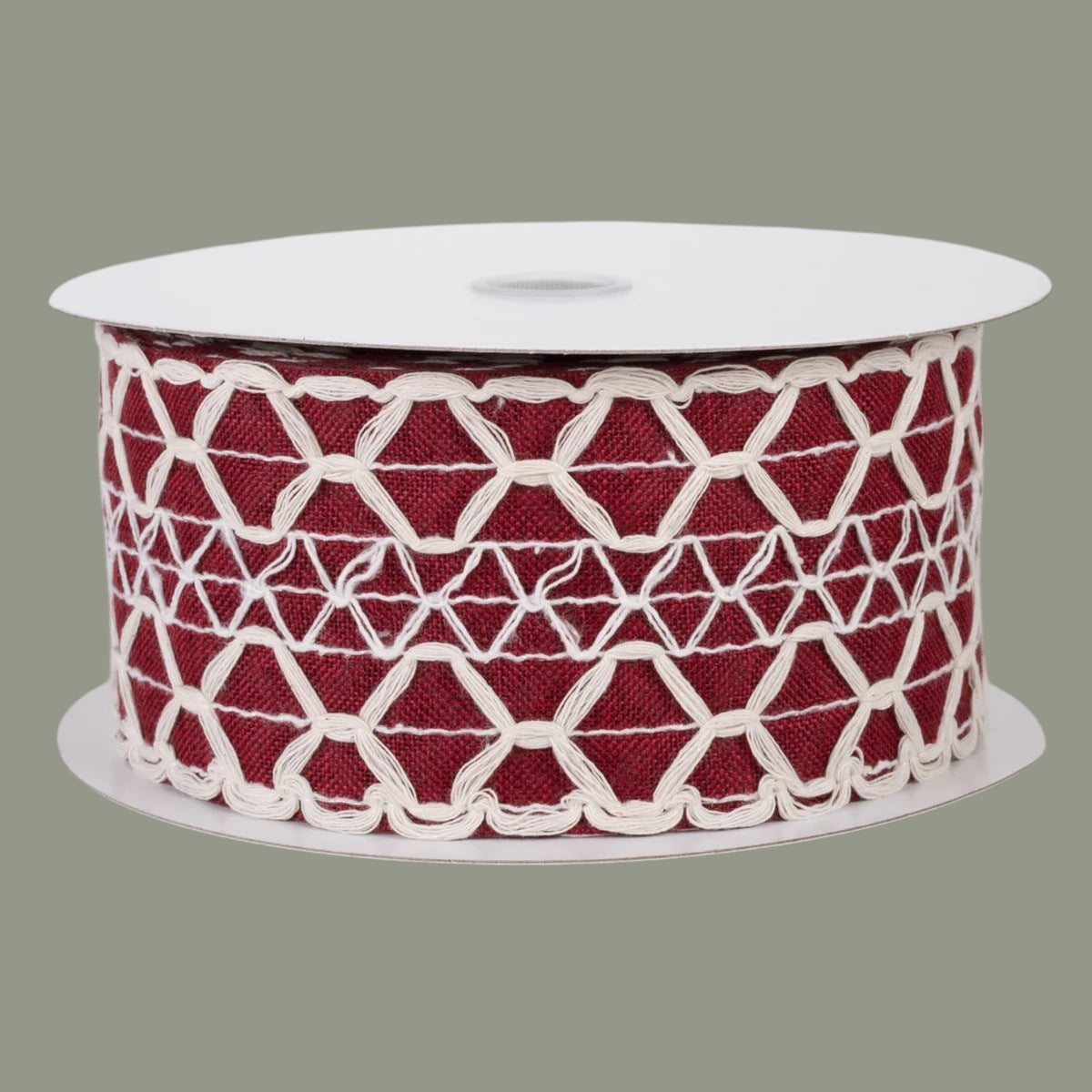 The Matthew John Collective dark red linen ribbon with ivory scalloped weave pattern and wired edges on a spool.