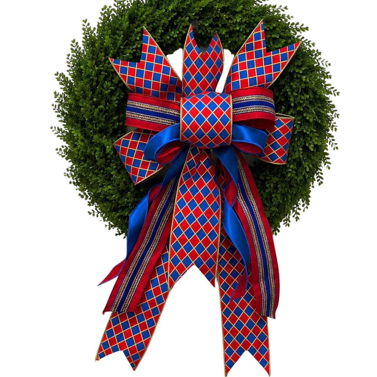 The Matthew John Collective handmade red, blue, and gold diamond patterned designer bow on a green boxwood wreath.