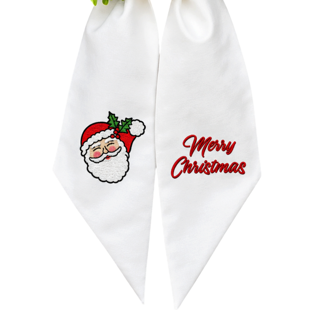 The Matthew John Collective white cotton canvas wreath sash with embroidered vintage Santa and Merry Christmas text.