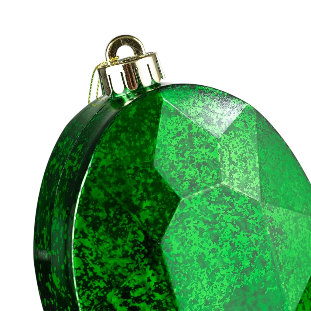 The Matthew John Collective emerald green oval gem ornament with a faceted mercury glass finish and gold cap.