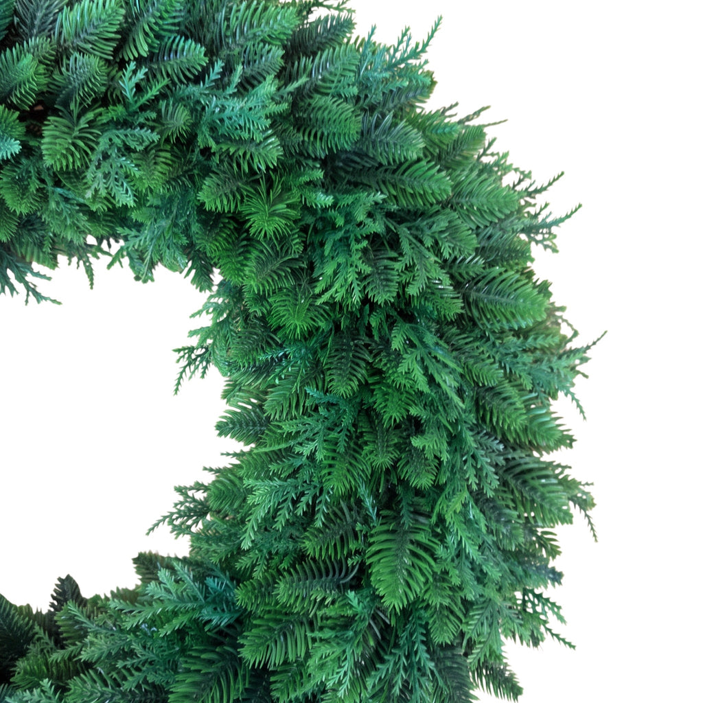 The Matthew John Collective 22-inch round mixed evergreen wreath with realistic faux cedar and pine foliage.