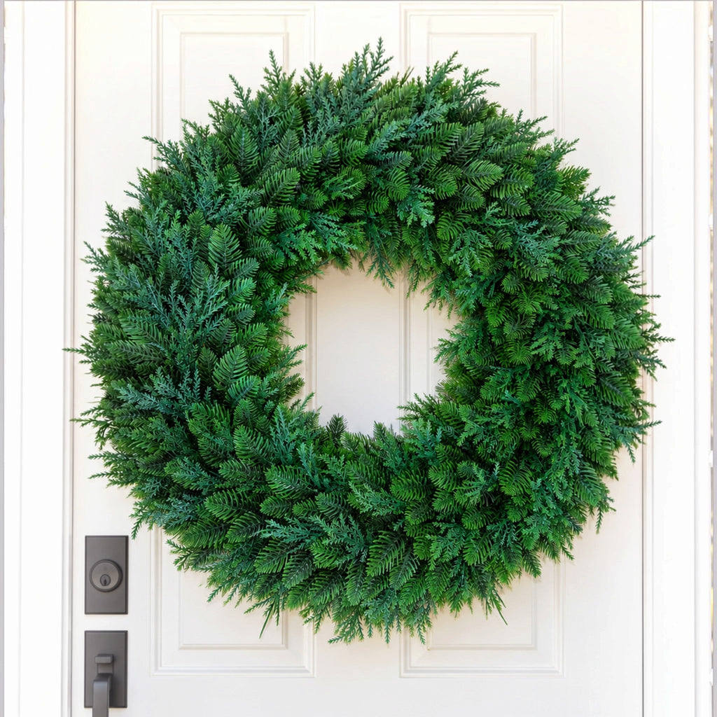 The Matthew John Collective 22-inch round mixed evergreen wreath with realistic faux cedar and pine on a white door.