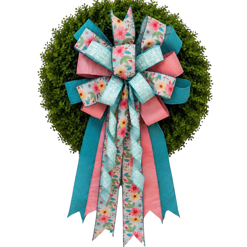 The Matthew John Collective Signature Seabreeze Floral Bow in teal and pink on a green boxwood wreath