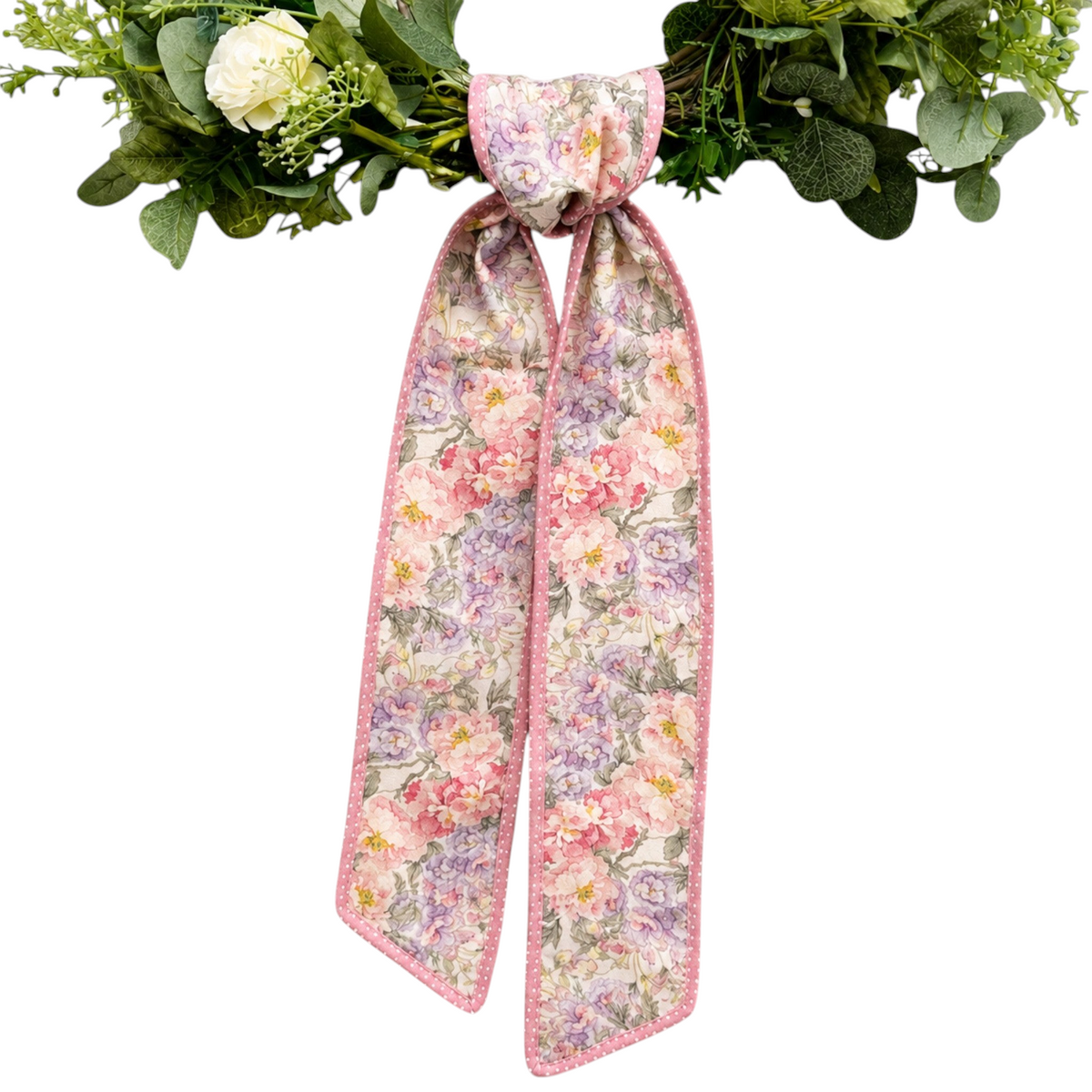 The Matthew John Collective D. Stevens floral wreath sash in pink and mauve with a polka dot backing on a green wreath