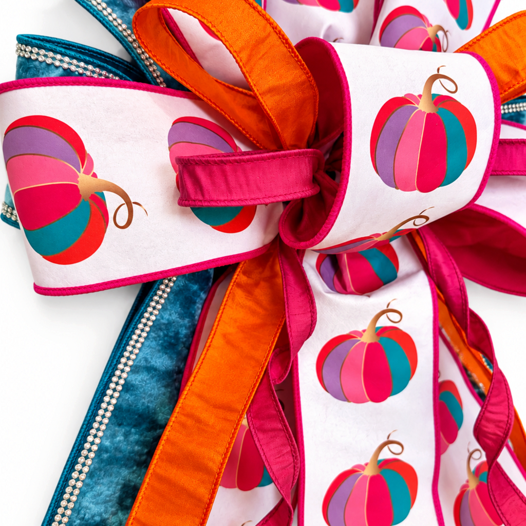 The Matthew John Collective oversized fall wreath bow with fuchsia pumpkin print, blue velvet, and rhinestone trim.