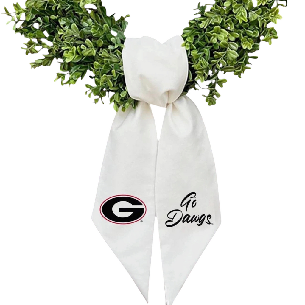 The Matthew John Collective white embroidered Georgia wreath sash with team logo and Go Dawgs text on green wreath.