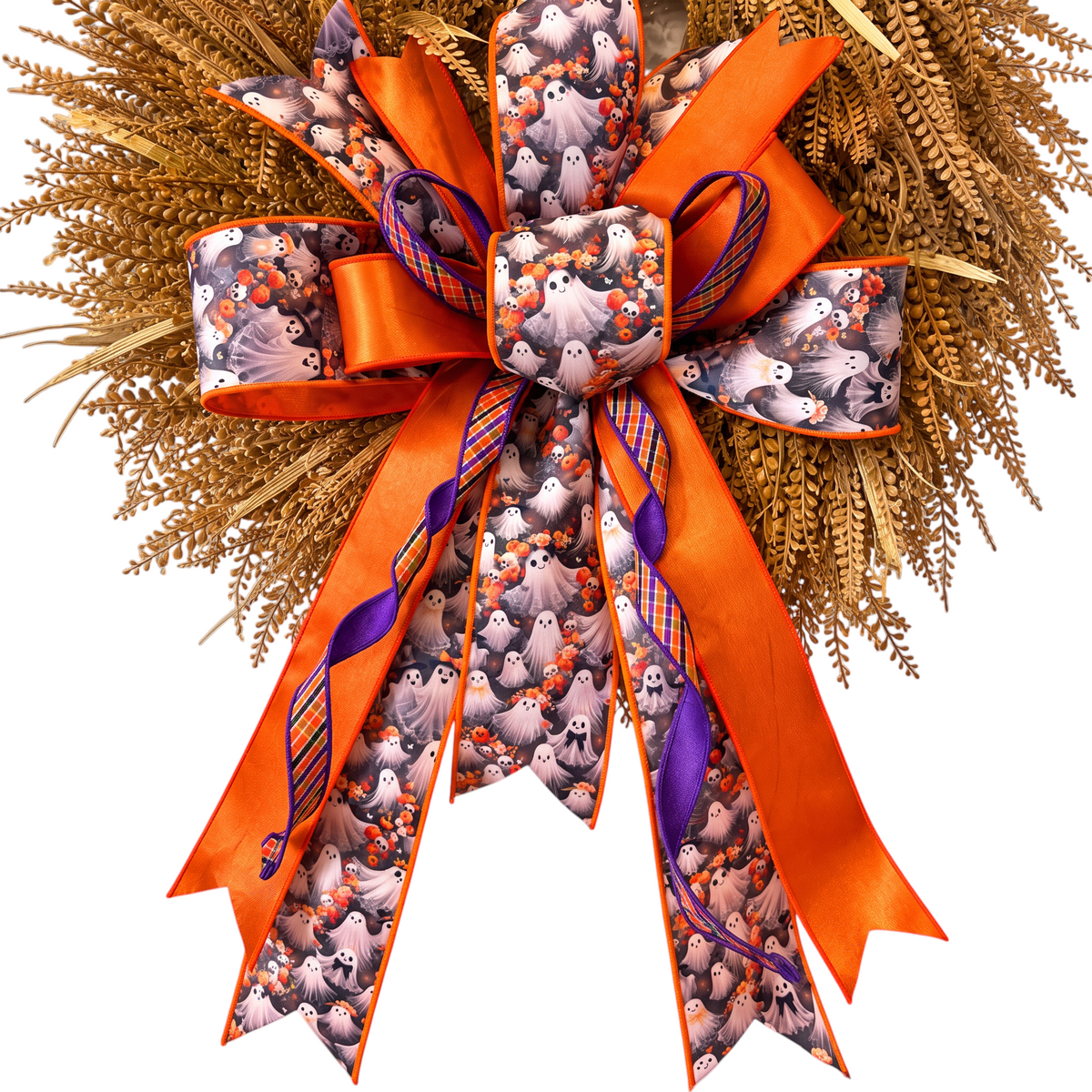 The Matthew John Collective oversized Halloween ghost wreath bow with orange, purple, and plaid ribbons on a wreath.