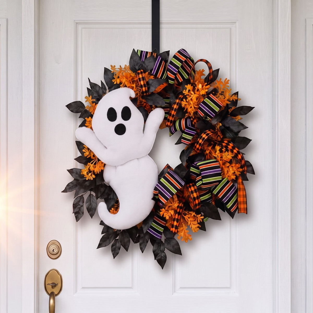 The Matthew John Collective 24-inch Halloween wreath featuring a plush ghost, black foliage, and striped designer ribbon.