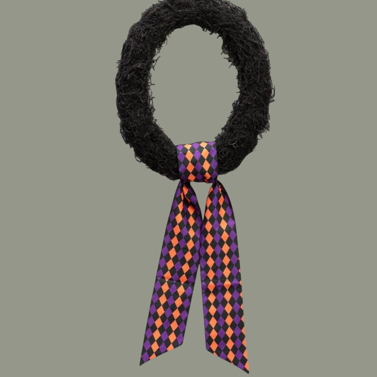 The Matthew John Collective D Stevens taffeta wreath sash featuring a black, purple, and orange harlequin diamond print.