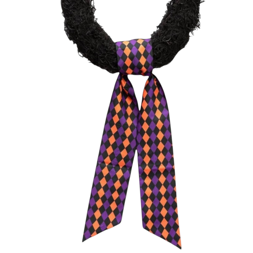 The Matthew John Collective D Stevens taffeta wreath sash featuring a black, purple, and orange harlequin diamond print.