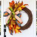 The Matthew John Collective Harvest Moon grapevine wreath with autumn foliage, pumpkin ribbon, and a designer bow.