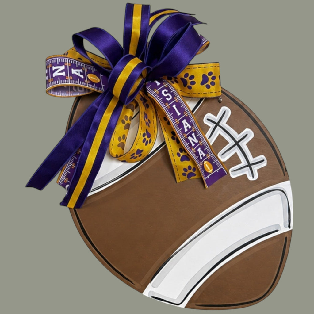 The Matthew John Collective LSU Tigers football door hanger with a purple and gold handmade designer bow