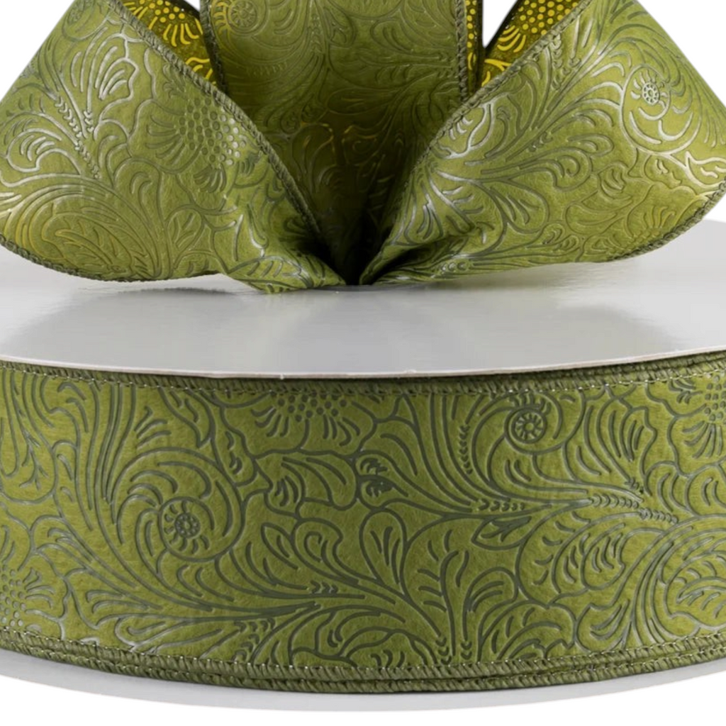 The Matthew John Collective moss green wired ribbon with an embossed floral pattern on non-woven fabric.