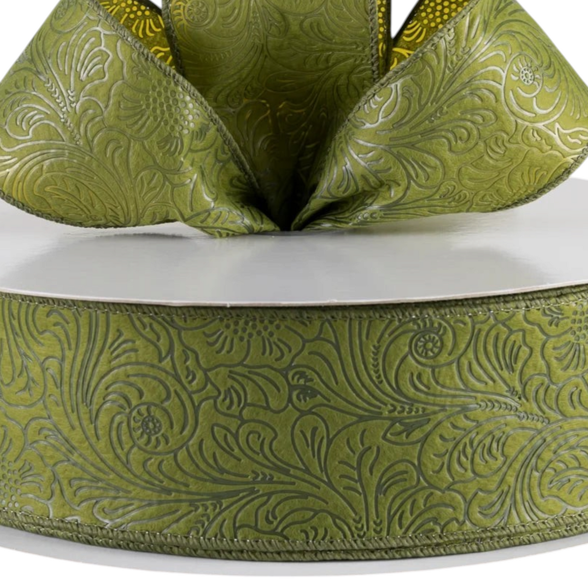 The Matthew John Collective moss green wired ribbon with an embossed floral pattern on non-woven fabric.