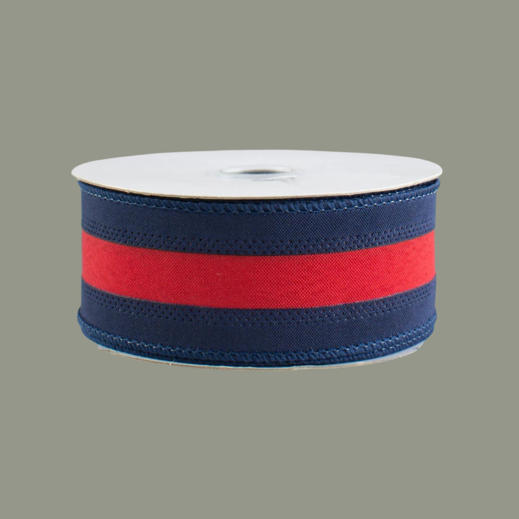 The Matthew John Collective 1.5-inch navy blue and red satin wired ribbon on a spool for crafting and gift wrapping.