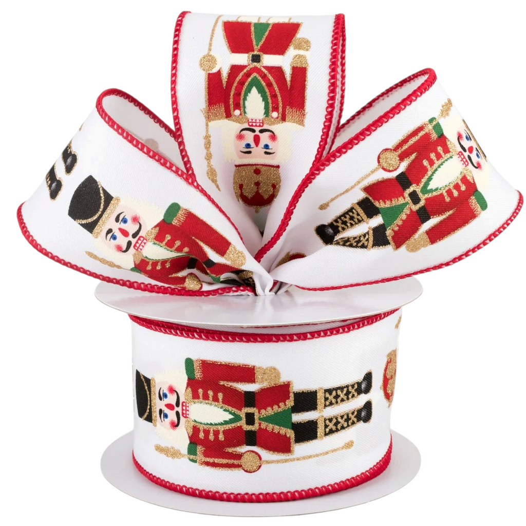 The Matthew John Collective nutcracker wired ribbon with red, green, and gold glitter details on white canvas
