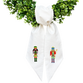 The Matthew John Collective white cotton canvas wreath sash with embroidered nutcracker soldiers on a green wreath.