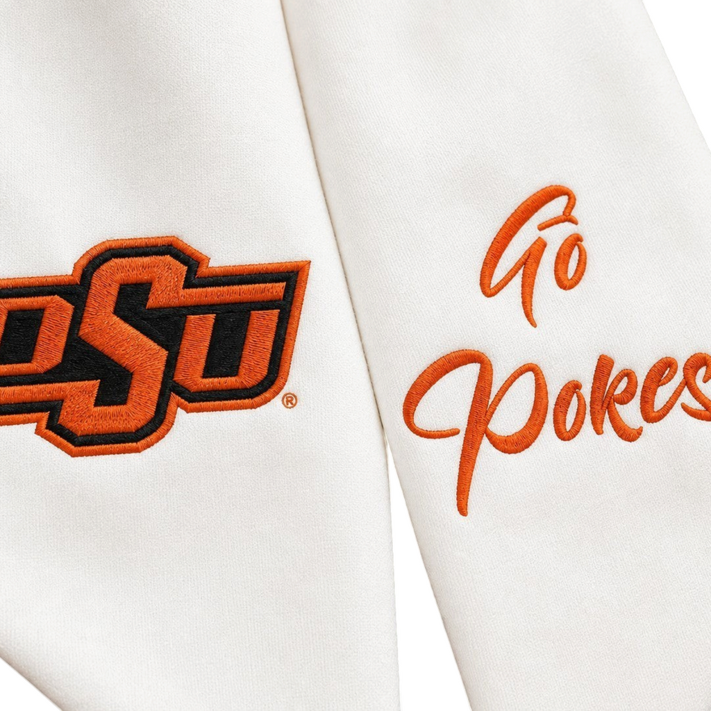 The Matthew John Collective white Oklahoma State wreath sash with orange and black OSU logo and Go Pokes embroidery.