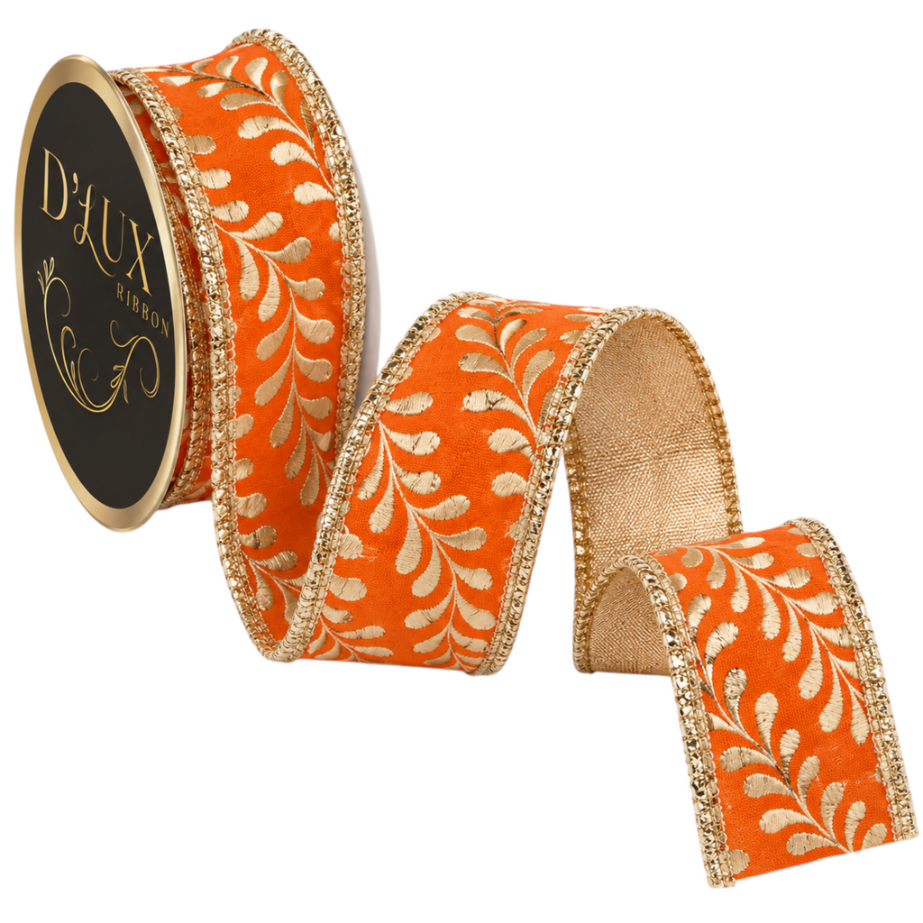 The Matthew John Collective orange ribbon with metallic gold foil leaf pattern and gold edges on a spool.