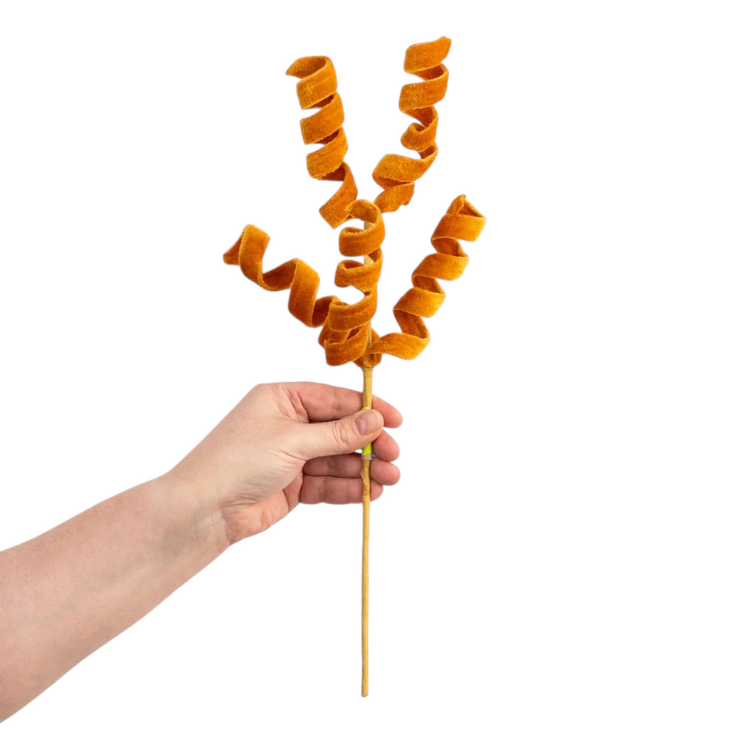 The Matthew John Collective harvest orange velvet curly spray with five adjustable wired spirals on a gold stem.