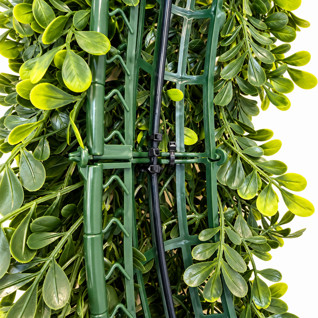 The Matthew John Collective oval artificial boxwood wreath showing the sturdy green plastic lattice frame construction.