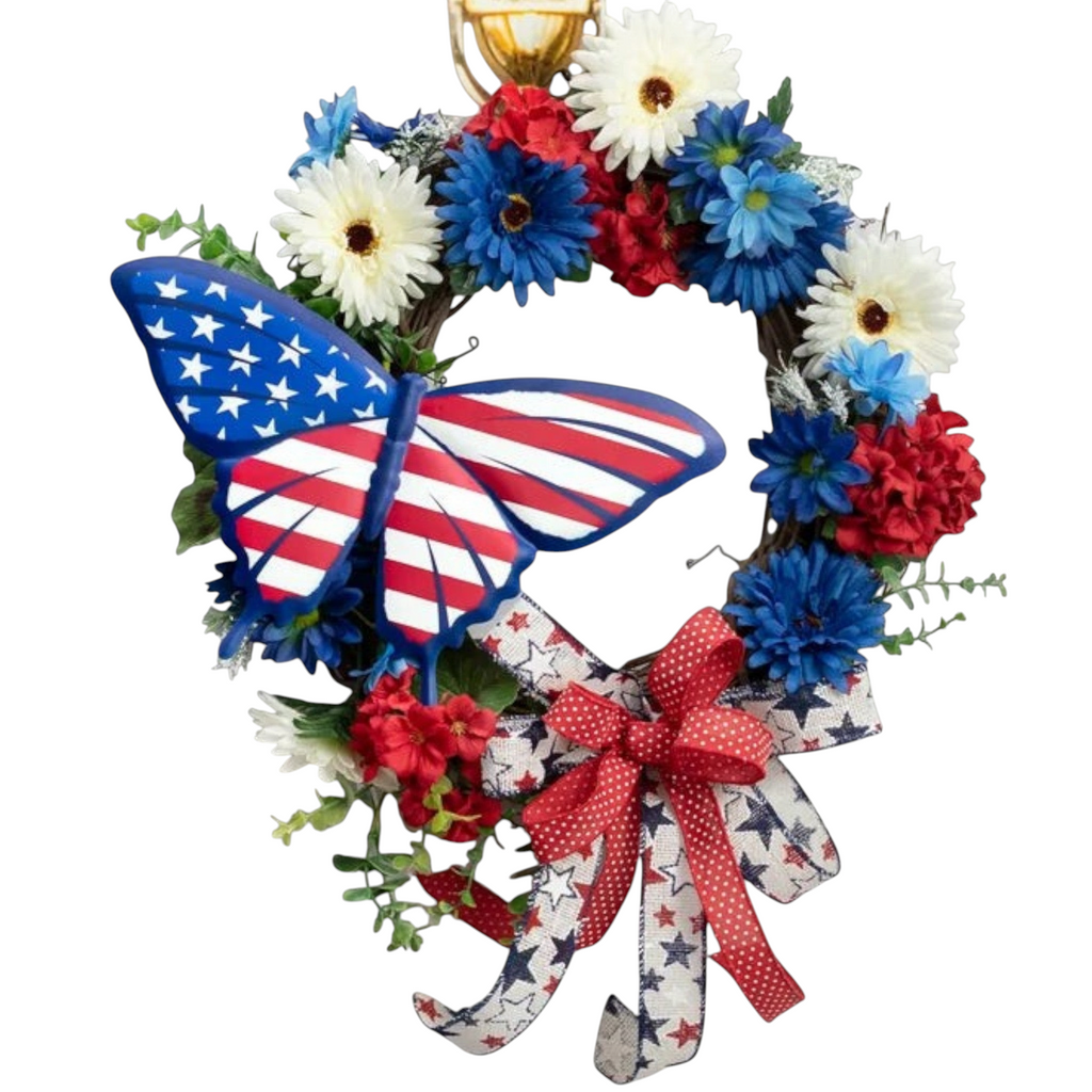 The Matthew John Collective patriotic swallowtail butterfly metal sign on a red, white, and blue floral wreath.