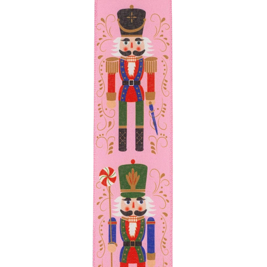 The Matthew John Collective pink wired edge ribbon featuring festive nutcracker figures and gold scrollwork patterns.