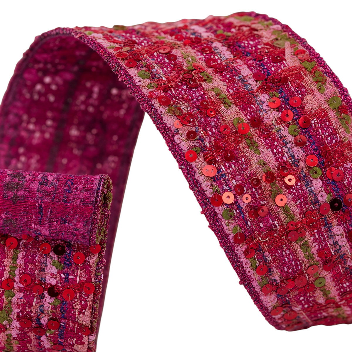 The Matthew John Collective Farrisilk Motley Tweed holiday ribbon in pink and red with shimmering sequin accents.