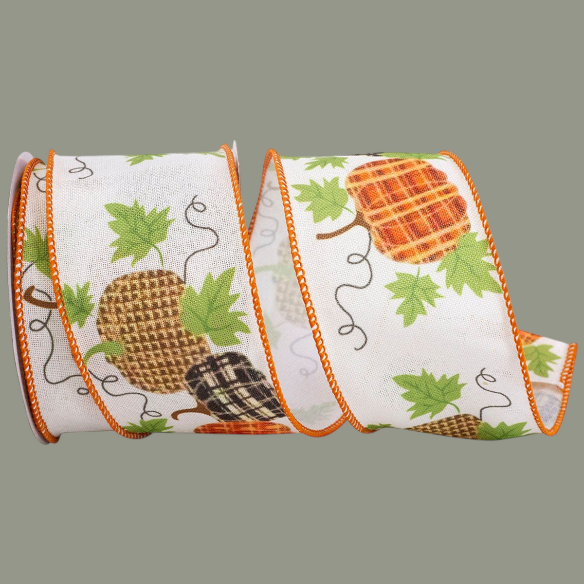 The Matthew John Collective muslin ribbon with pumpkin patterns, green leaves, and orange wired edges for fall decor.