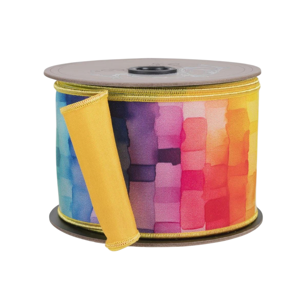 The Matthew John Collective 2.5-inch taffeta ribbon with a rainbow watercolor mosaic cube pattern on a spool