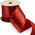 The Matthew John Collective 4-inch red and gold sequin Christmas ribbon with a smooth red taffeta backing on a spool.