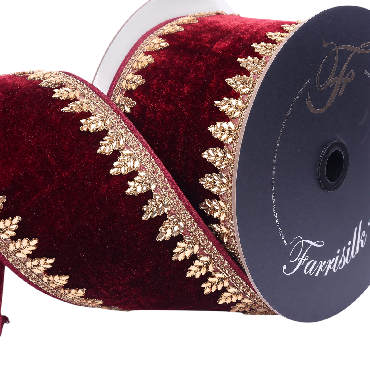 The Matthew John Collective Farrisilk ruby red velvet holiday ribbon with intricate gold metallic leaf-patterned trim.