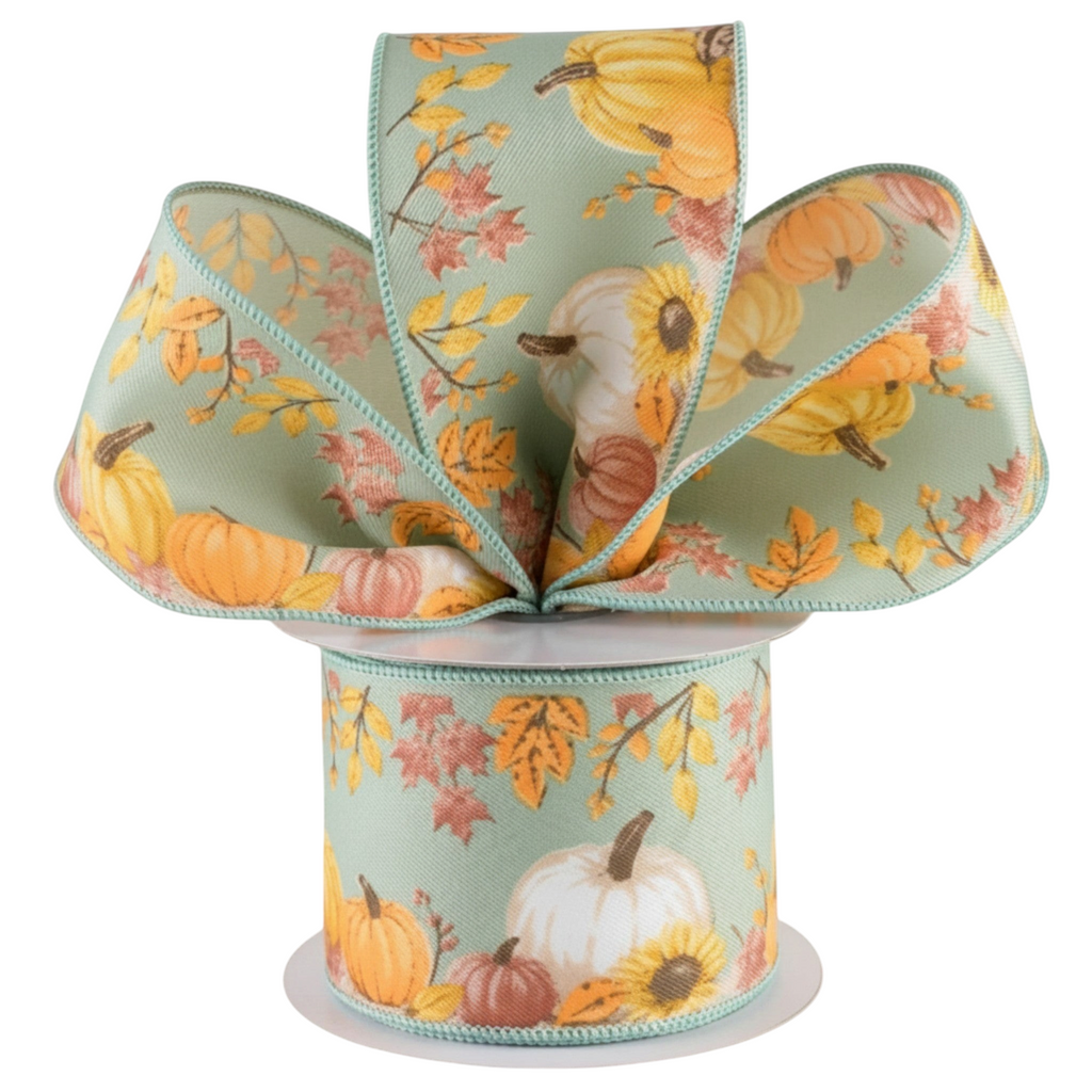 The Matthew John Collective sage green wired ribbon featuring orange pumpkins, sunflowers, and fall foliage patterns.