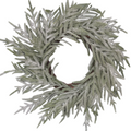 The Matthew John Collective 22-inch snowy Norfolk pine wreath with realistic needles on a dark blue front door.