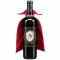 The Matthew John Collective vampire wine bottle cape in red and black, draped over a dark wine bottle.