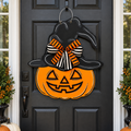 The Matthew John Collective hand-painted wooden jack-o'-lantern door hanger with a witch hat and striped bow.