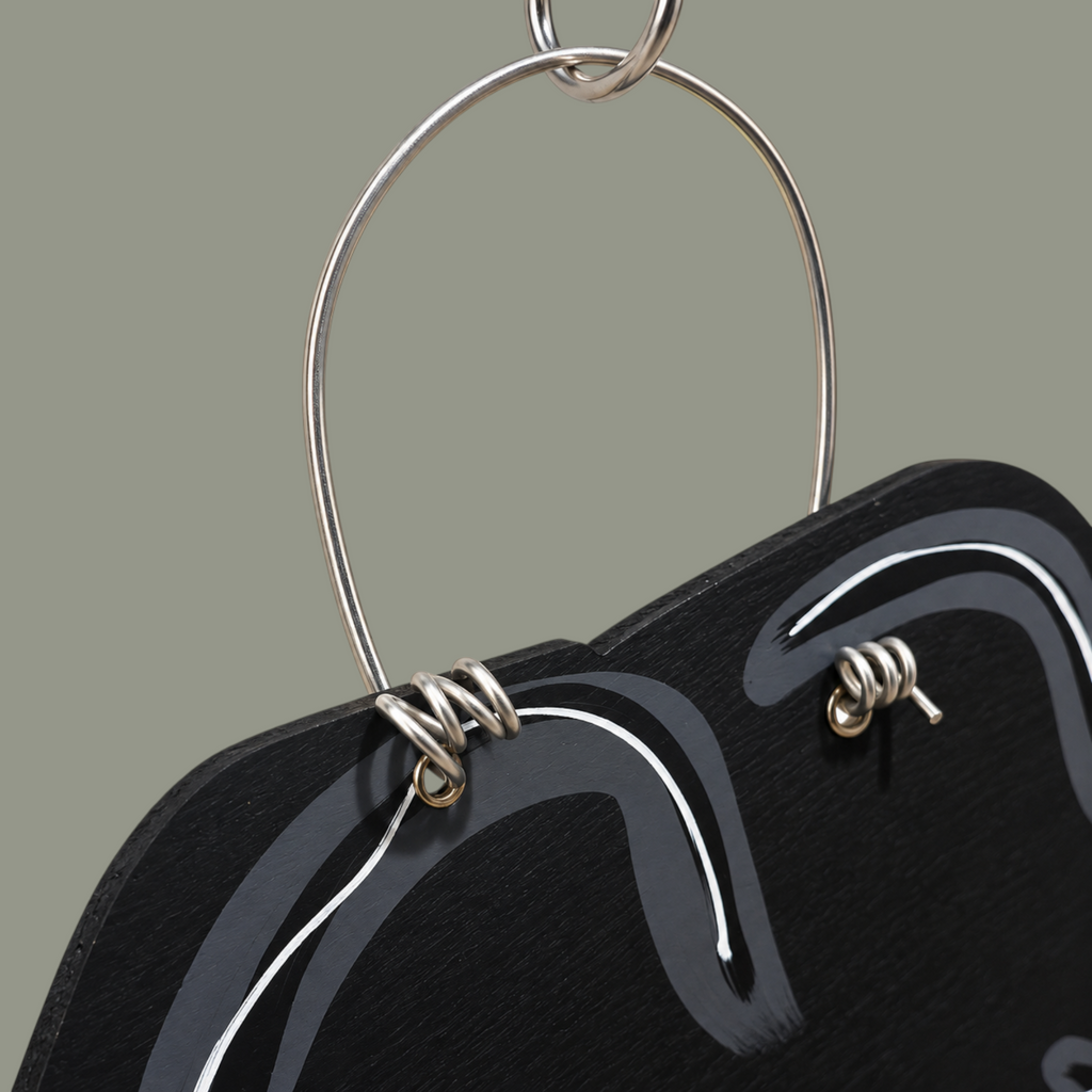 The Matthew John Collective hand-painted wooden jack-o-lantern witch hat door hanger with sturdy wire hanging loop.